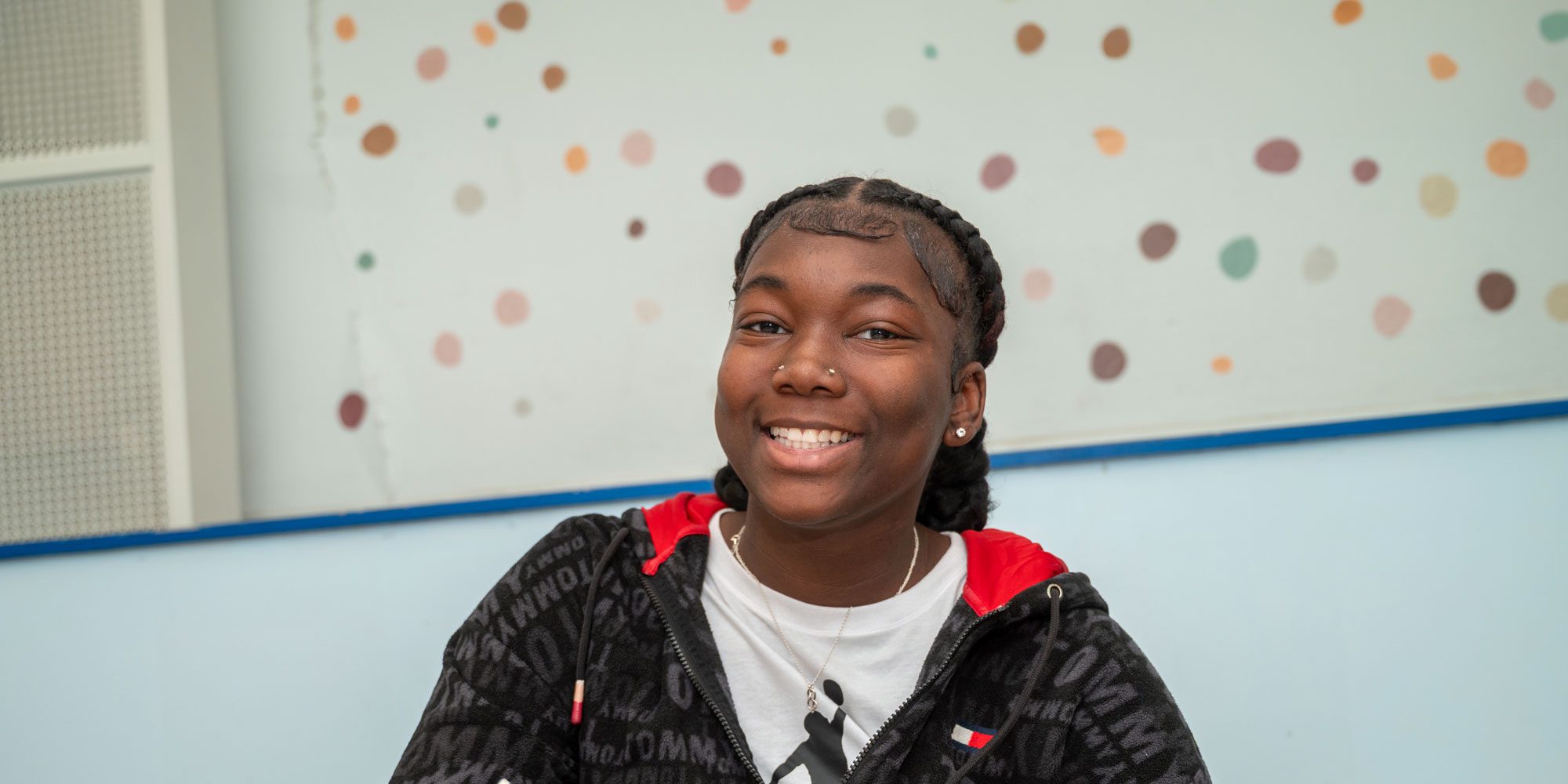 Smiling student in a classroom.